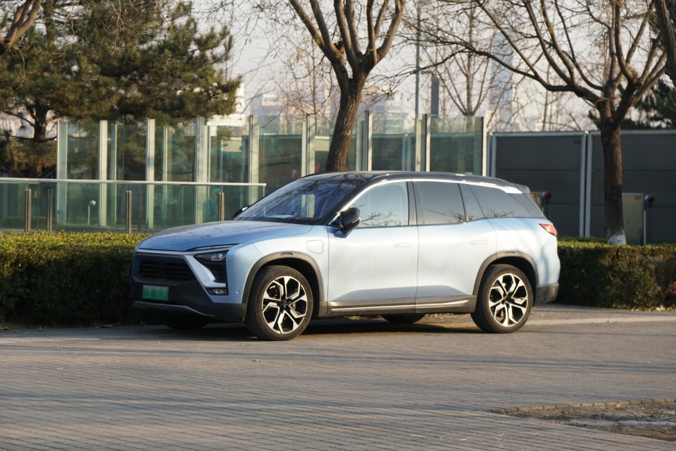 A light blue electric SUV, parked in a residential area.