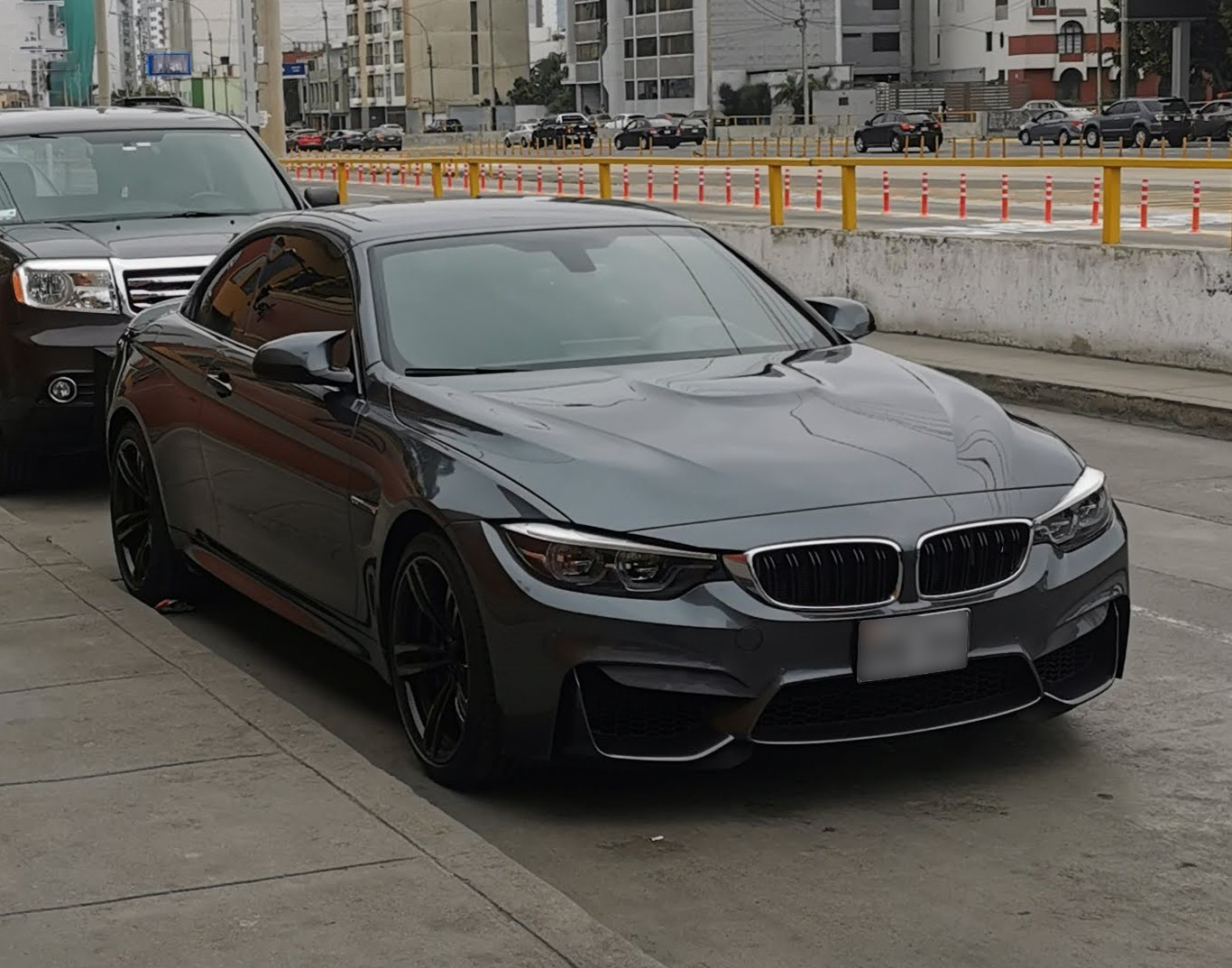 A gray sporty coupe, parked on a city street.