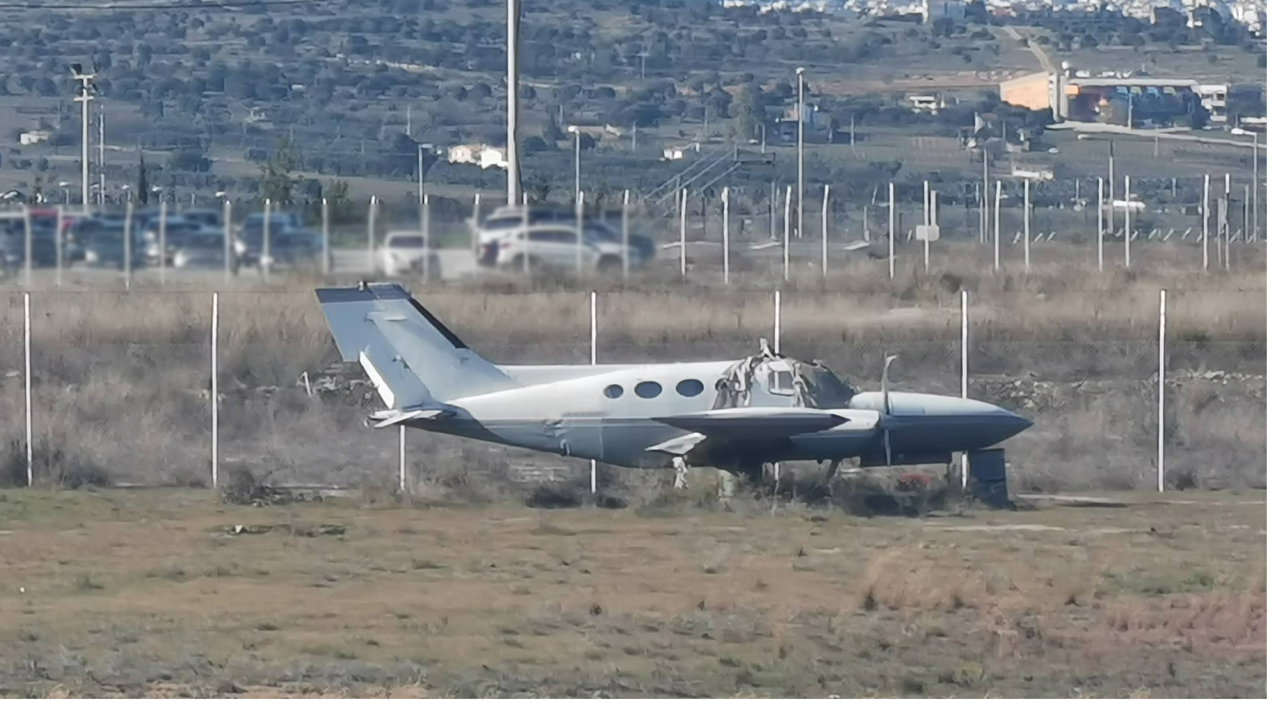 An small aircraft parked on a field.