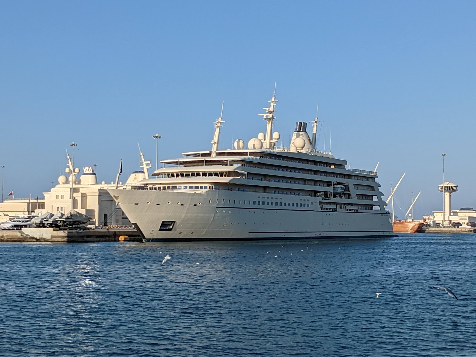A luxury yacht docked at a marina.